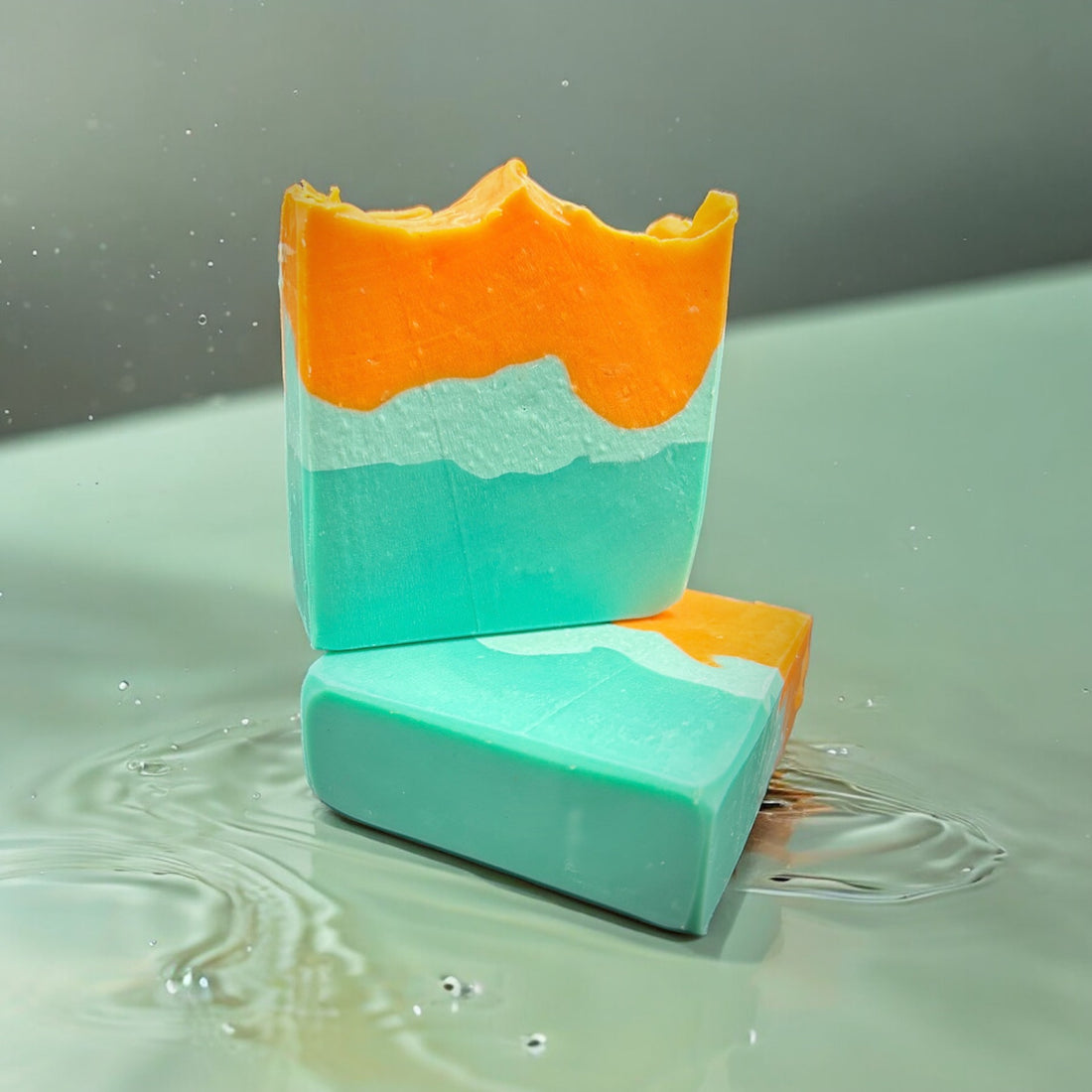 Green and Orange soap bars in water 